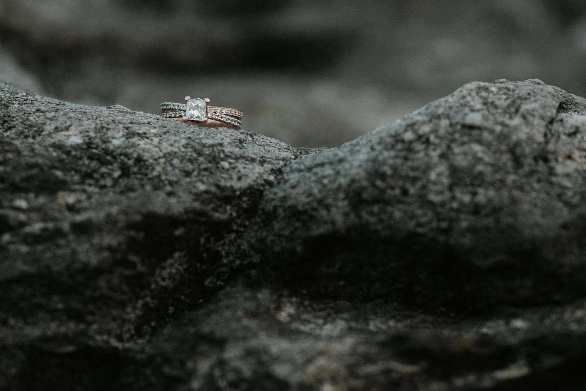 grey gold-colored clear gemstone encrusted ring on rock roan mountain